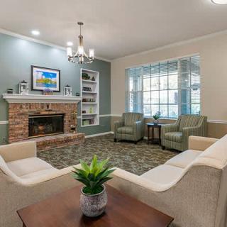 A cozy living room with a fireplace, comfortable seating, and tasteful decor.