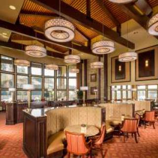 A warmly lit restaurant interior with elegant seating and stylish lighting fixtures.