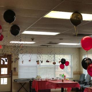 A festive party setup featuring red and black balloons, creating a lively atmosphere.