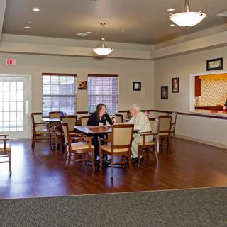 Two people having a conversation in a cozy dining area.
