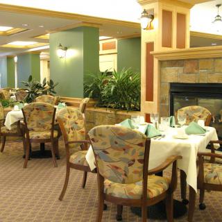 A cozy and elegant dining area with neatly arranged tables and chairs, ready for guests.