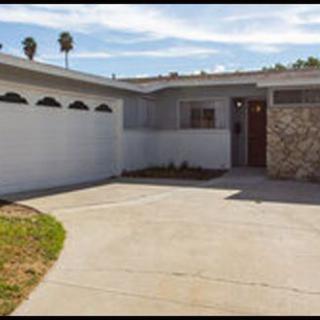 A suburban single-story house with a garage and driveway.