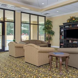 A cozy lobby area with sofas and a television.