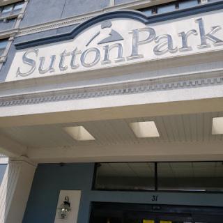 The entrance to Sutton Park, showcasing its distinctive sign and architectural details.