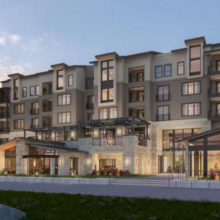 A modern apartment building with multiple floors, featuring a stylish exterior in the evening light.