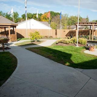 A beautifully landscaped outdoor area with a winding pathway and lush greenery.