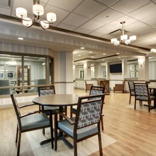 A modern dining area featuring stylish furniture and warm lighting.