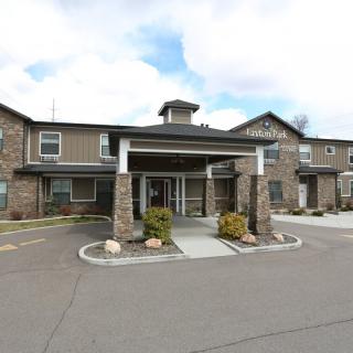 A modern building with a welcoming entrance and landscaped surroundings.