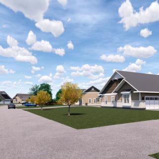 A suburban neighborhood featuring modern houses with a clear blue sky and scattered clouds.