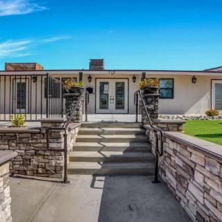 Front view of a modern house with stone accents and landscaped entryway.