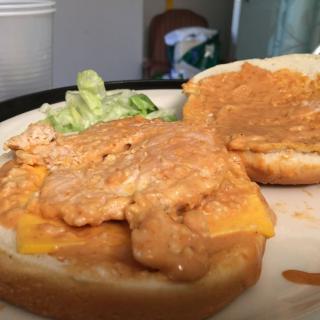 A sandwich with lettuce and a creamy filling on a plate.