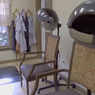 An interior view of a beauty salon featuring hair dryers and chairs.