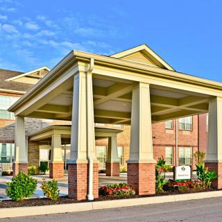 Front entrance of a hotel featuring prominent columns and landscaping.