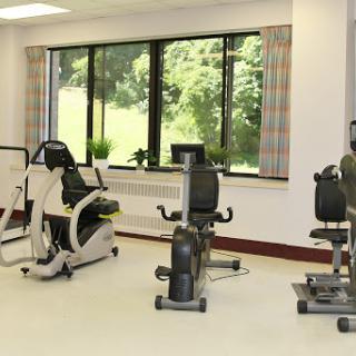 A well-equipped fitness center featuring various exercise machines, perfect for rehabilitation and workouts.