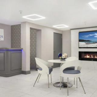 A modern lobby with contemporary furniture and a fireplace.