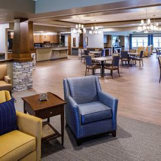 A spacious and well-lit lounge and dining area with comfortable seating and stylish decor.