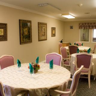A cozy dining room featuring elegantly set tables and tasteful decor.
