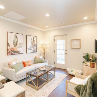A modern and inviting living room with comfortable furniture, stylish artwork, and bright lighting.
