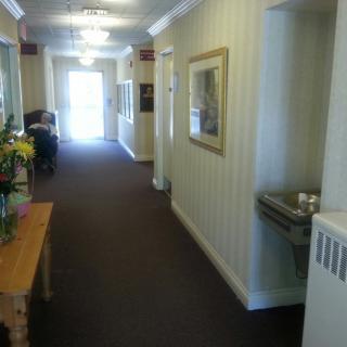 A well-lit hallway with a water fountain and decorative elements.