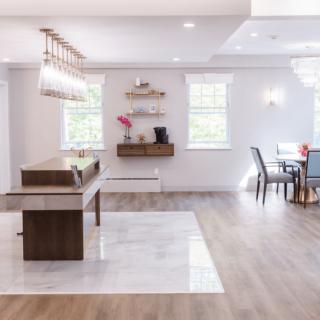 A modern open-plan kitchen and dining area with natural light and stylish furnishings.