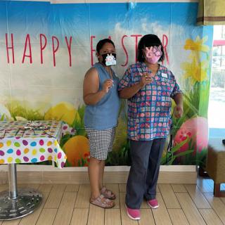 Two friends celebrating Easter together indoors, sharing a joyful moment.