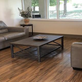 A modern living room featuring a sleek coffee table and comfortable sofas on hardwood flooring.