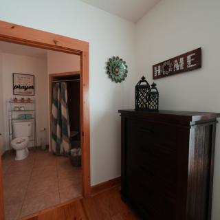 A cozy home interior with a view into the bathroom and decorative elements.