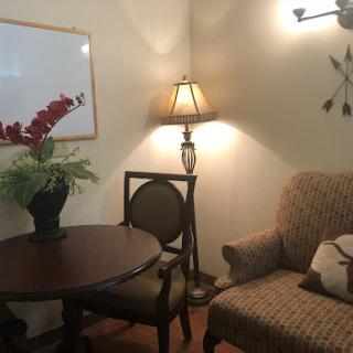 A cozy corner in a living room featuring comfortable seating and decorative elements.