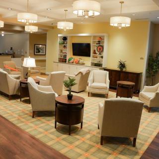 A cozy lobby with comfortable seating and warm lighting.