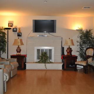 Cozy living room with a fireplace, television, and comfortable seating.