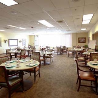 A spacious dining area with neatly arranged tables and chairs, providing a welcoming atmosphere.