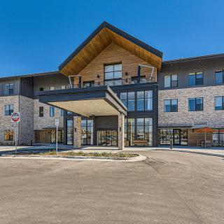 A modern commercial building with a prominent entrance and contemporary architectural design.
