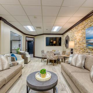 A cozy living room with comfortable sofas, a central coffee table, and decorative artwork on the walls.