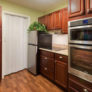 Modern kitchen with stainless steel appliances and wooden cabinetry.