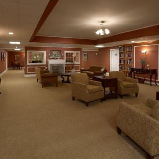 A spacious living room with comfortable seating, a fireplace, and warm lighting.