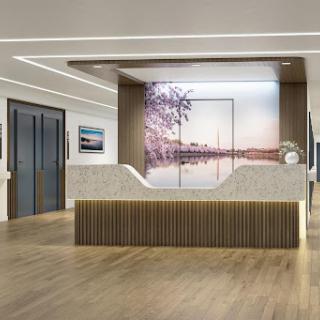 A sleek and modern reception area featuring elegant wood accents and a scenic artwork backdrop.
