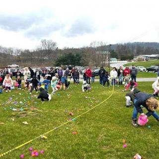 Children and families enjoy a lively Easter egg hunt in a community park.