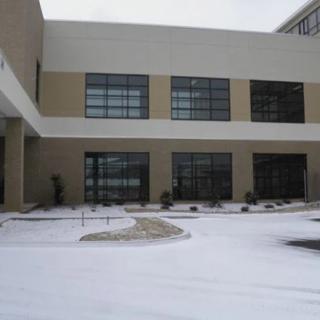 A building exterior with snow covering the ground.