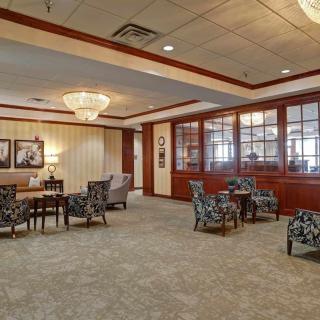 A spacious and elegantly decorated lobby with comfortable seating and chandeliers.