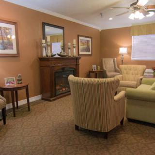 A cozy living room with warm lighting and comfortable seating.