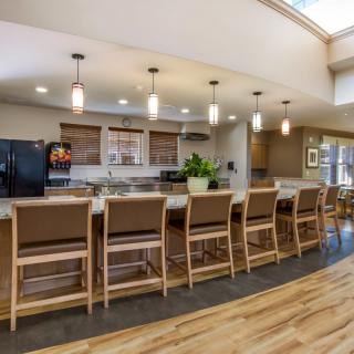 Modern kitchen interior with a long counter and seating.