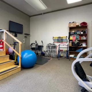 A physical therapy room equipped with various rehabilitation tools and exercise equipment.