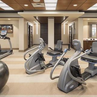 A modern gym with various fitness equipment and exercise machines arranged neatly.