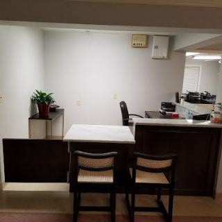 A modern office space featuring a desk with chairs and a potted plant.