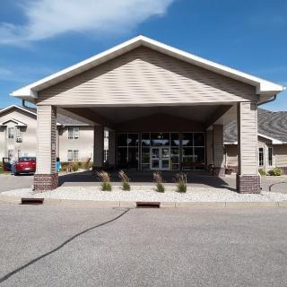 A building with a large covered entrance and clear skies.