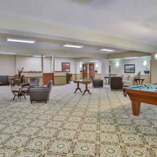 Spacious lounge area with seating and a pool table.