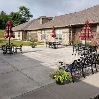 A serene outdoor courtyard with seating and umbrellas, perfect for relaxation.