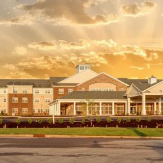 A hotel building under a dramatic sunset sky.