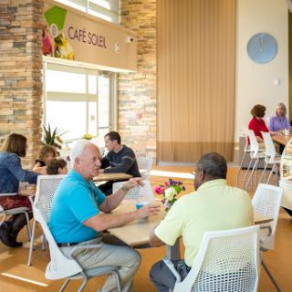 A vibrant caf scene with people enjoying their time and engaging in conversation.