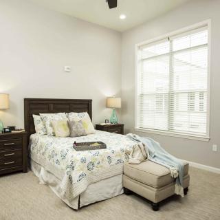 A cozy bedroom with elegant decor and ample natural light.